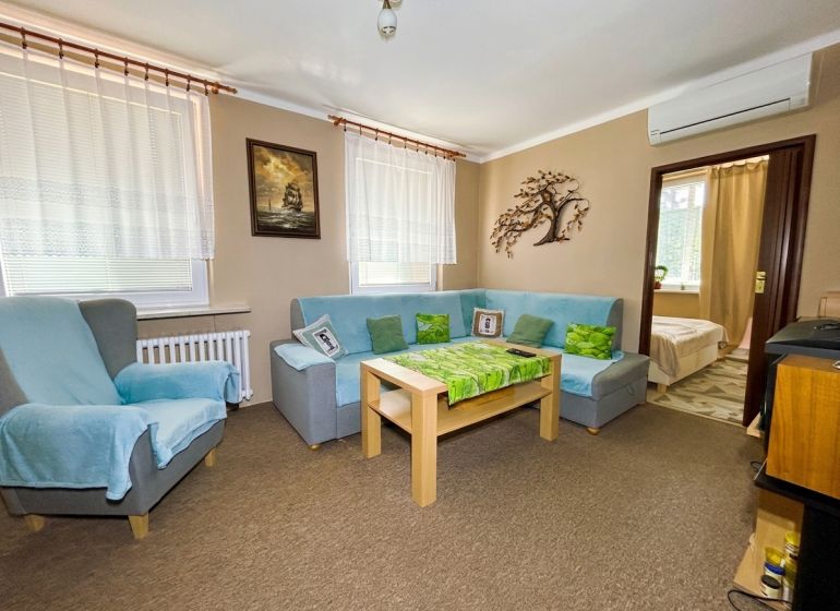 Living room with comfortable seating in a 4-room apartment, entrance to the room.