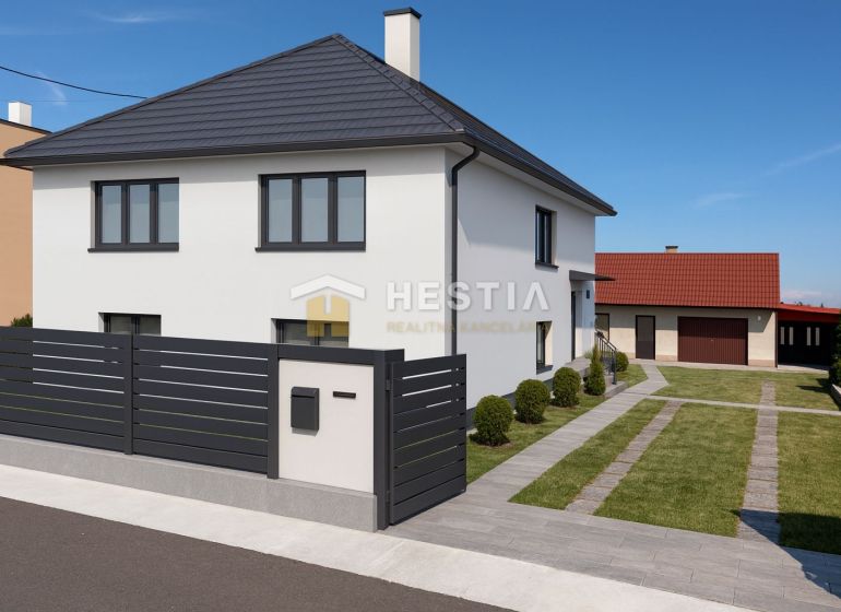 A family house in Šajdíkových Humence with an elegant fence and a landscaped garden.