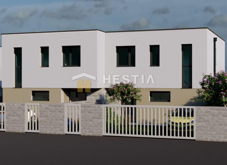 A two-story building with trees and a fence in Rovensko.