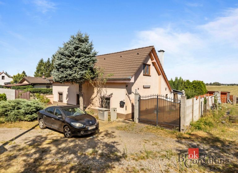 A family house in Veľké Leváre, a car on the driveway, a garden, and part of the fence.