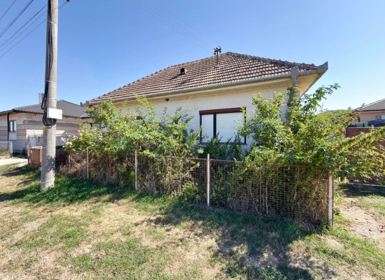 A family house in Hruboňovo with a fenced front garden and a gable roof.