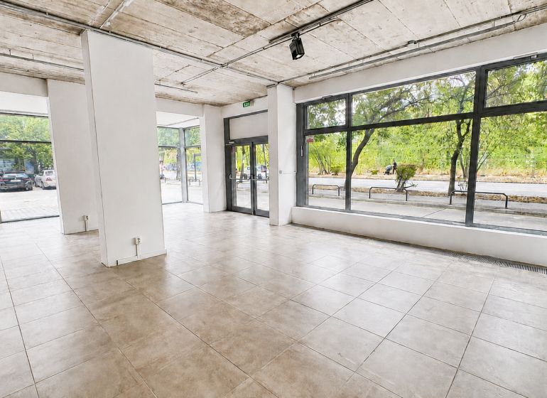 Spacious commercial premises with large glass display windows and tiling.