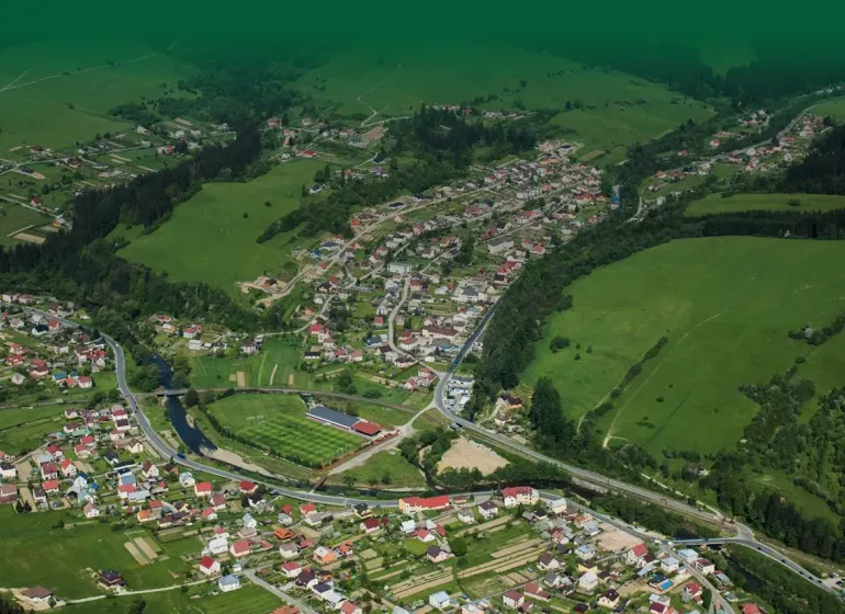 Aerial view of agricultural and forest land in Olešná with buildings and roads.