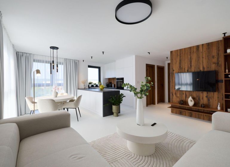Living room in a 4-room apartment with a wooden decor floor, light furniture, and decorations.
