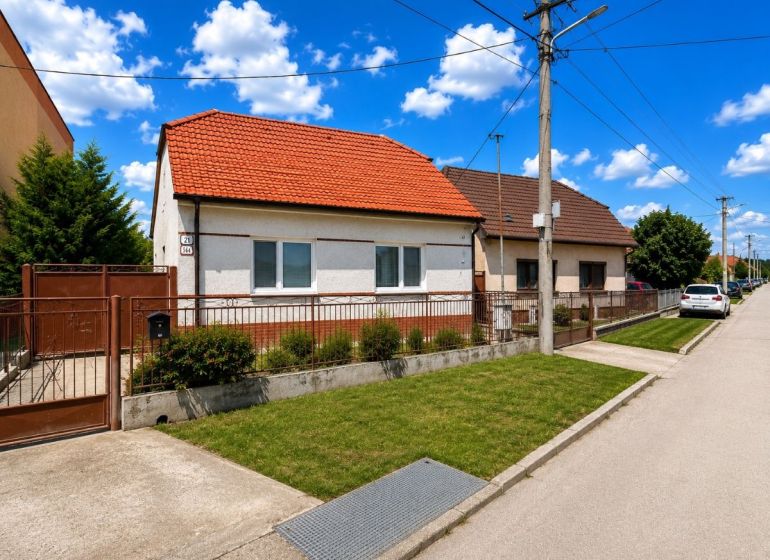 A family house on Orechova Street in Brestovany with a red roof and green lawn.
