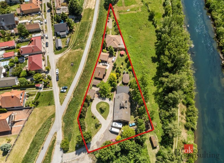 Aerial view of a family house in Hamuliakovo by the river, with marked plots.