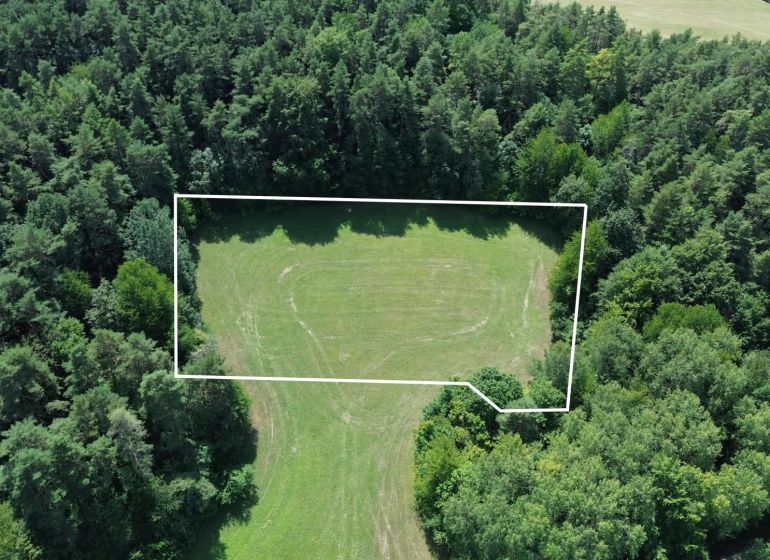 Aerial view of agricultural and forest land surrounded by forest in Dubnica nad Váhom, Medzihorie.