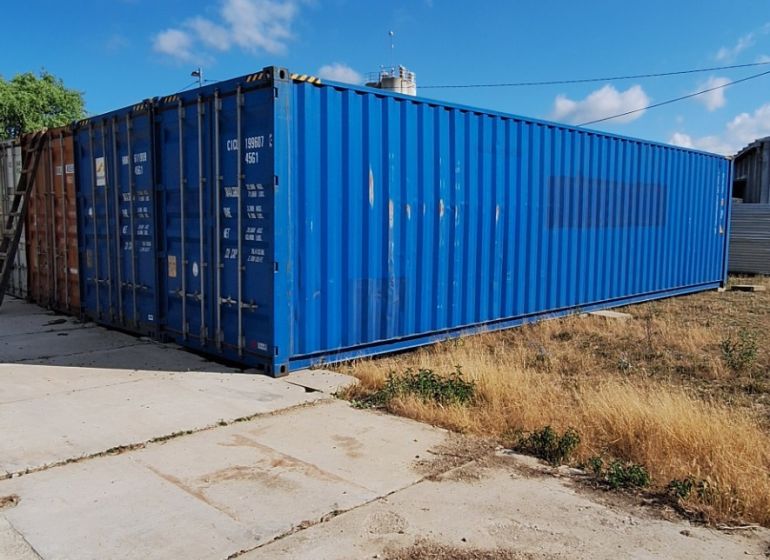 Storage containers outdoors in Sokolovce under a blue sky.