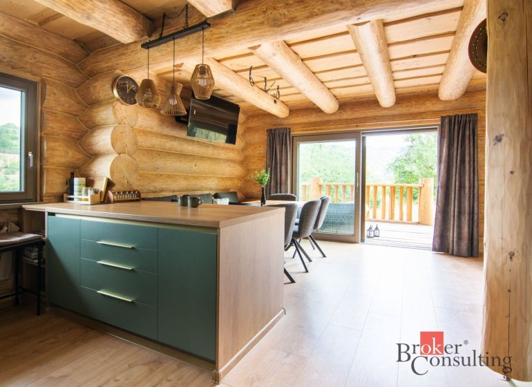 Interior of a family house with wooden decor and a kitchen island.