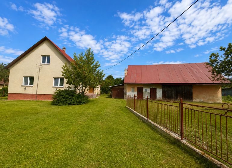 A family house in Oščadnica on Oščadnica Street with a spacious garden and a farm building.