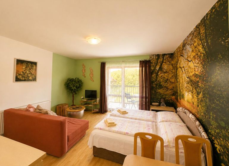 1-bedroom apartment with a wooden decor floor, natural motif on the wall, sofa, bed.