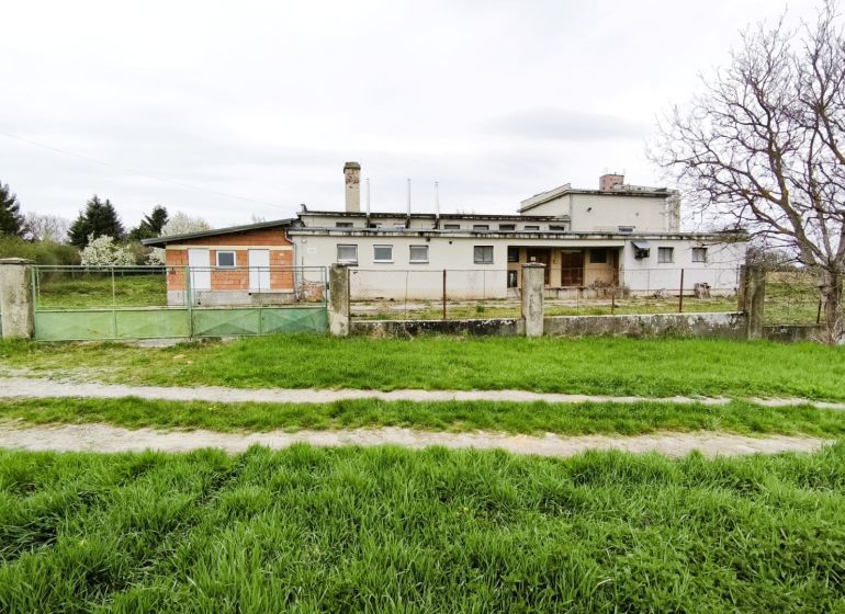 Production premises in Lesenice, fenced, with a large grassy plot and access road.