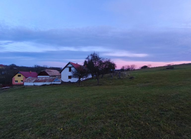 A family house on Prieloh in Dolná Strehová surrounded by nature at dusk.