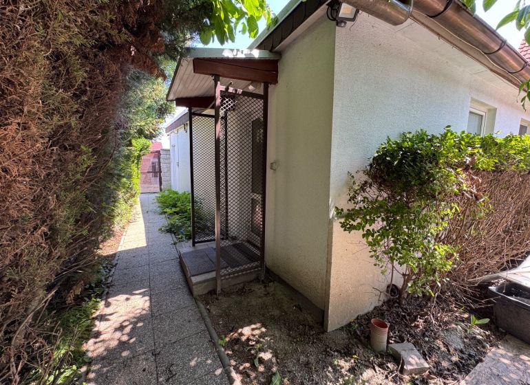 Family house on Senná Street in Bratislava - Ružinov, side garden with a walkway.