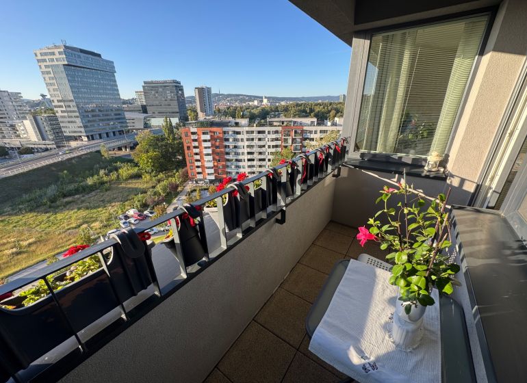 A balcony with plants and a view of Bosákova Street, Bratislava - Petržalka.