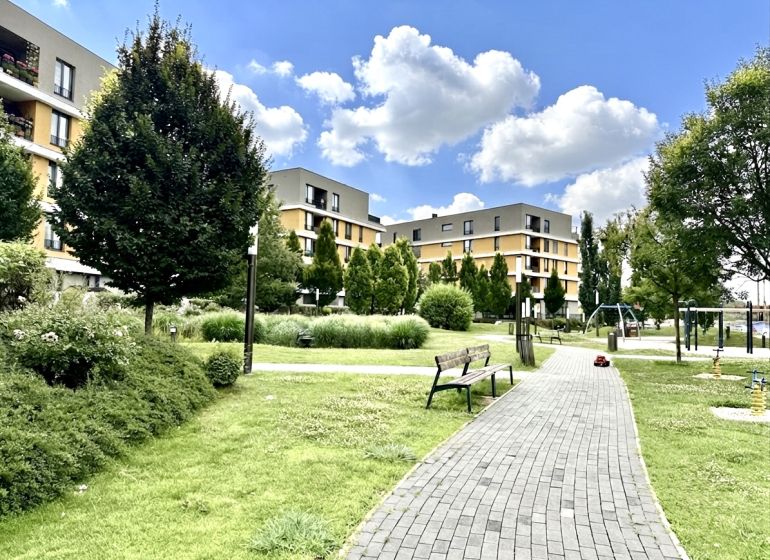 Residential complex with a park and playground on Bajkalská in Bratislava, Ružinov, surrounded by greenery.