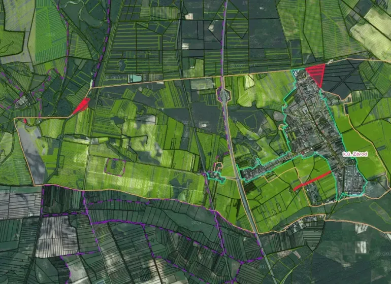 Aerial view of agricultural and forest lands in the village of Závod with road infrastructure.