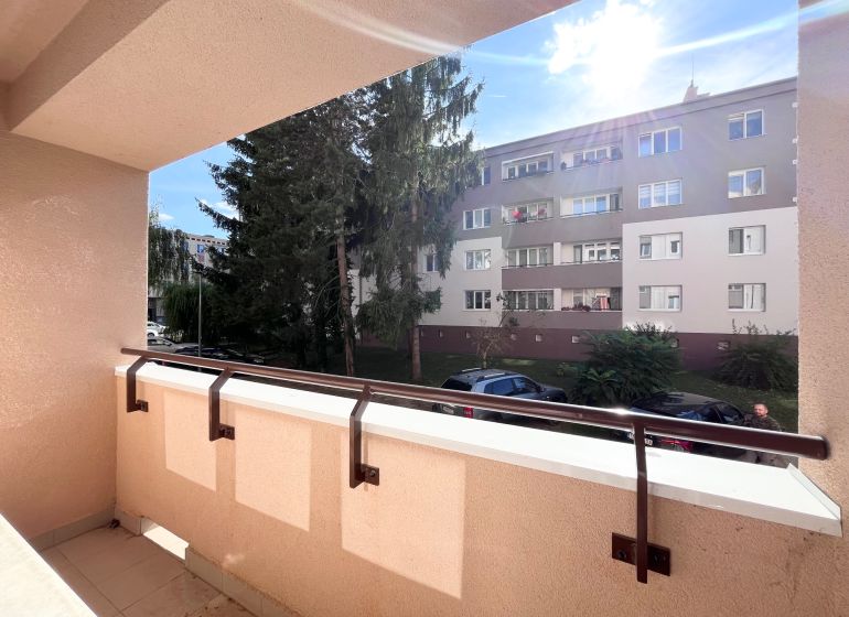 The balcony of a 3-room apartment on Švermova Street, Trenčín with a view of the surrounding building.