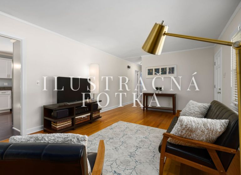 Living room in a 3-room apartment, with a sofa and television, floor with wooden decor.