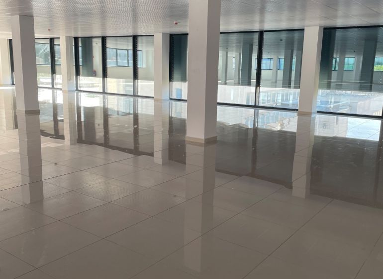 Spacious commercial spaces with large windows and shiny floors.