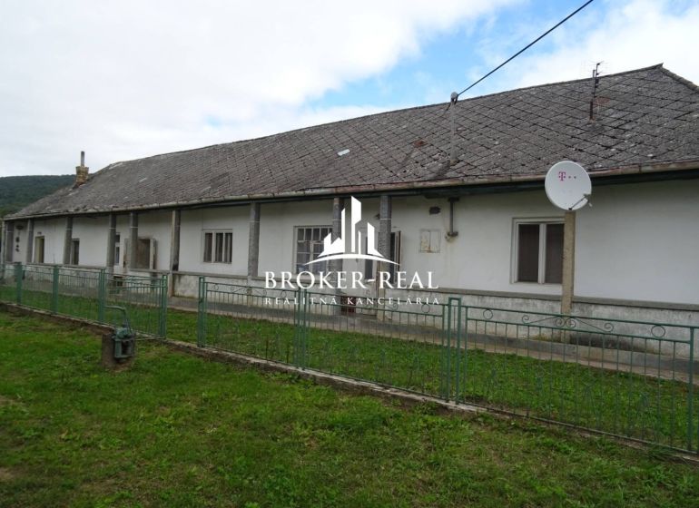 A family house in Černochov, surrounded by greenery, with a satellite dish on the roof.