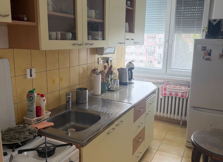 A kitchen in a 2-room apartment with a kitchen unit and appliances.