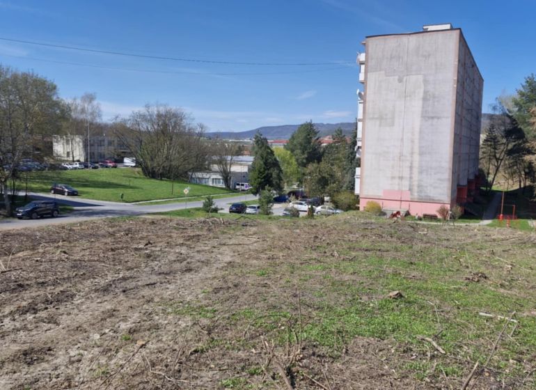 In Veľký Krtíš on Železničná Street, commercial plots are visible.