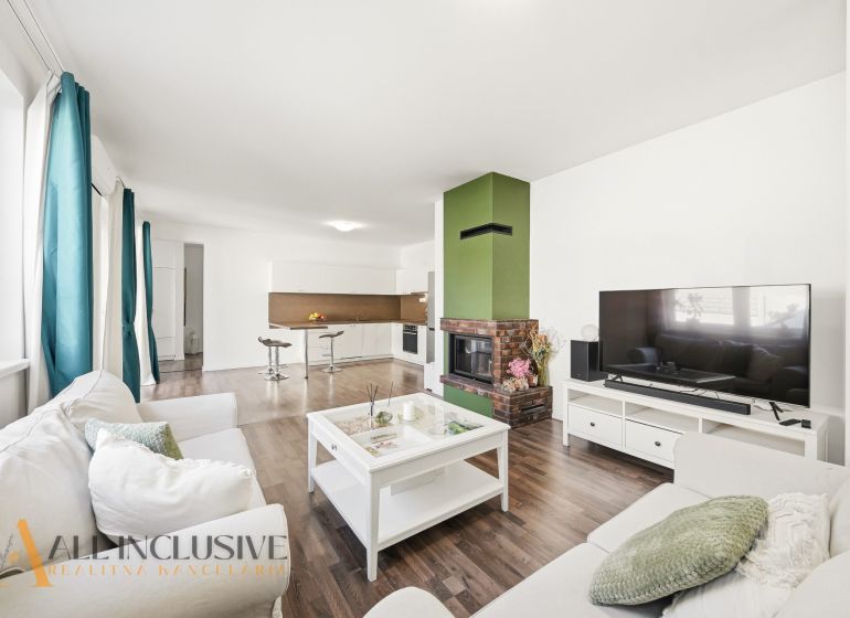 Living room in a 3-room apartment with a fireplace and a wooden decor floor.