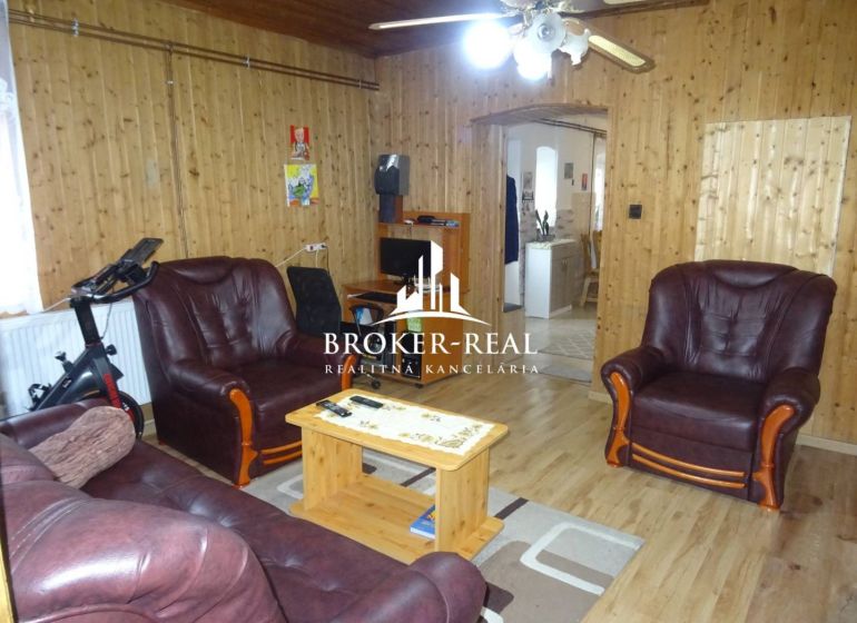 Interior of a family house with leather sofas and a wooden decor floor.