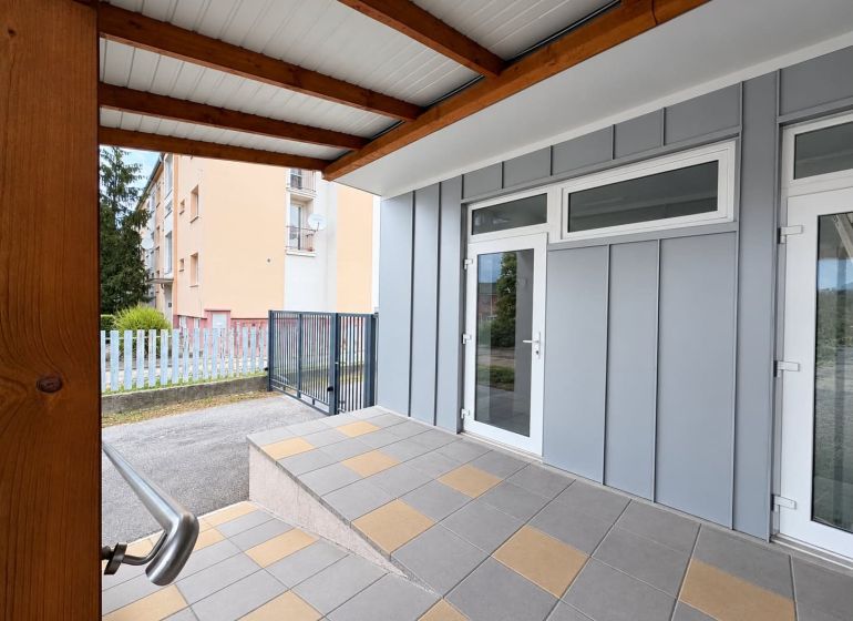Commercial premises in Komárno with glass entrance doors and a terrace canopy.