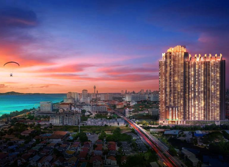View of the recreational apartment tower in Jomtien, sunset over the sea.
