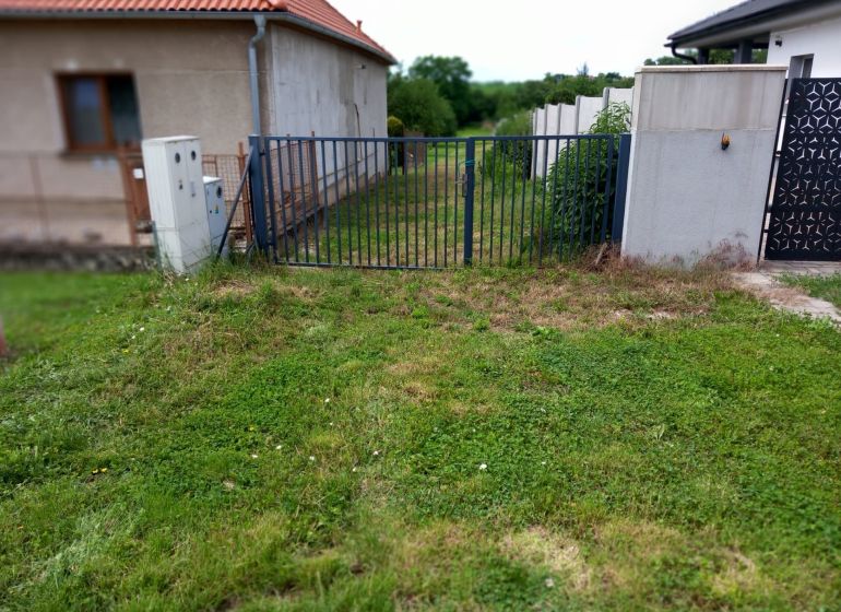 A grassy plot with fencing in Beladice suitable for living.