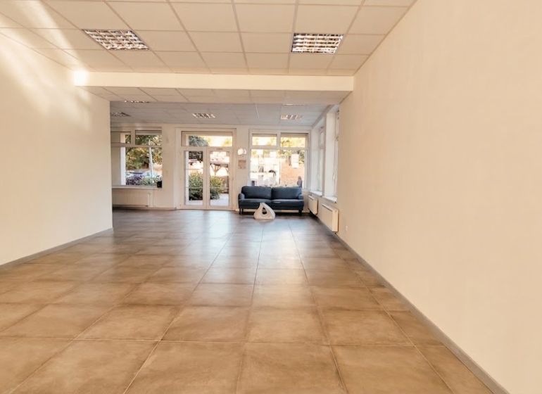 Spacious offices with tiled floors and large windows bring in natural light.