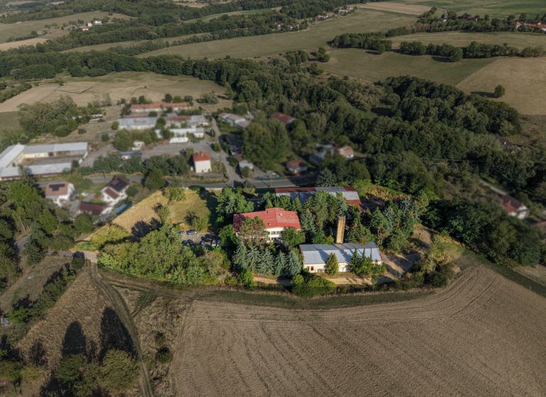 Aerial view of development plots in Slatinské Lazy surrounded by nature and buildings.