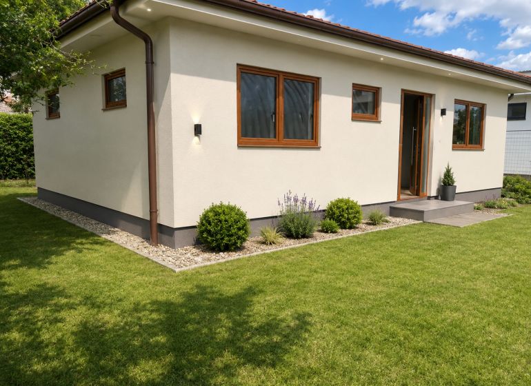 A family house in Šamorín with a well-maintained lawn and simple garden planting.