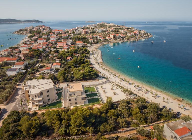 Aerial view of Sevid and a holiday apartment by the coast with a beautiful beach.