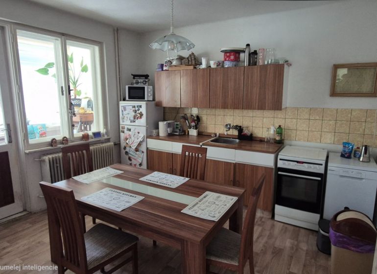 A kitchen in a family house with a dining table, white cabinets, and wooden decor.