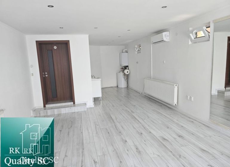 White walls, wood-patterned flooring, and air conditioning characterize the commercial spaces.
