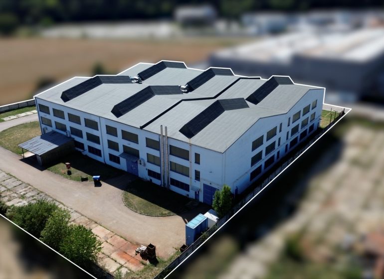 White building in the complex of warehouses and halls on K výstavisku street in Trenčín.