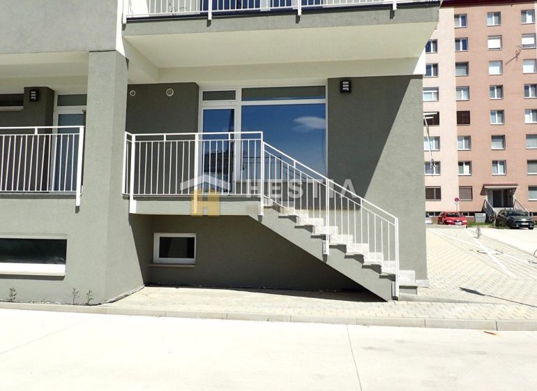 Commercial land in Senica with a staircase and a modern building facade.