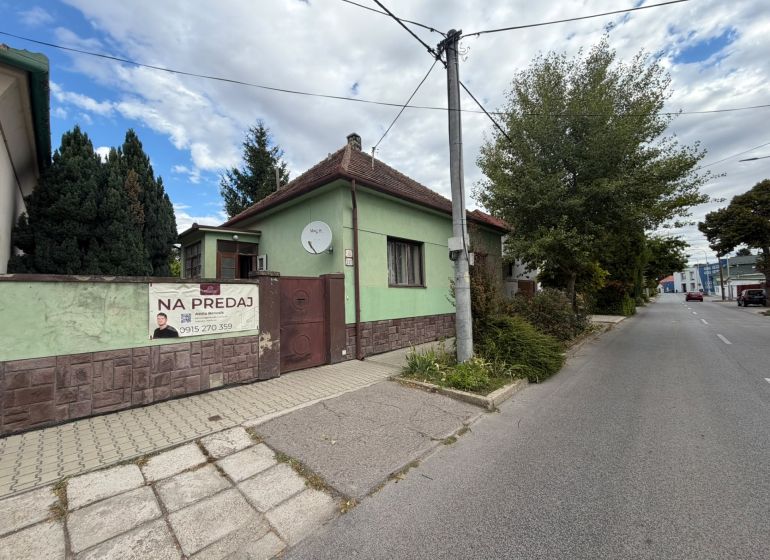 A family house on Šulekova Street in Nové Zámky, surrounded by greenery and a sidewalk.
