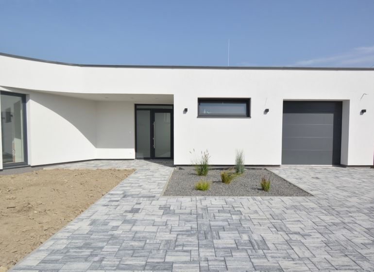 Family house on Kráľovianky in Šamorín with paving and a minimalist garden.