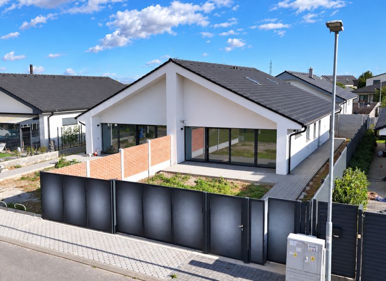 A family house on Cífer Street in Trnava with large windows and a garden behind the fence.