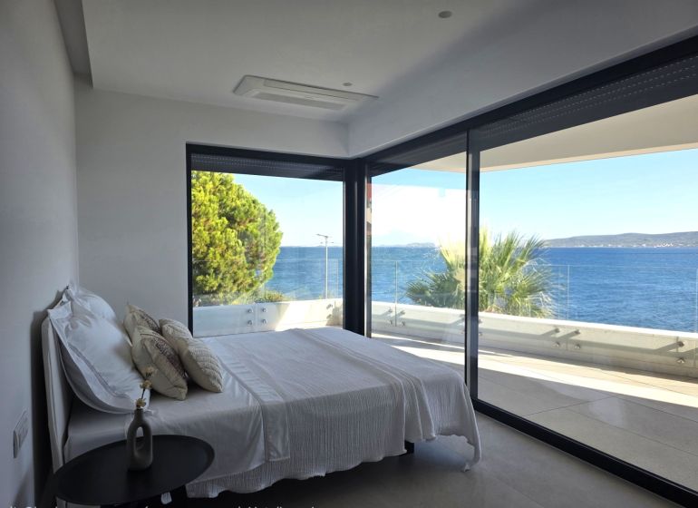 A bedroom in a 4-room apartment with a sea view and a balcony.