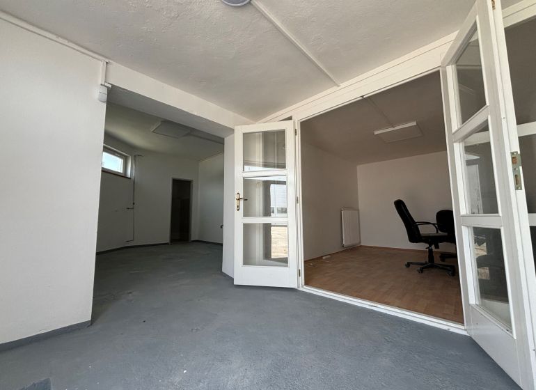 Interior with folding doors, office chair, and wooden decor flooring, warehouses and halls.