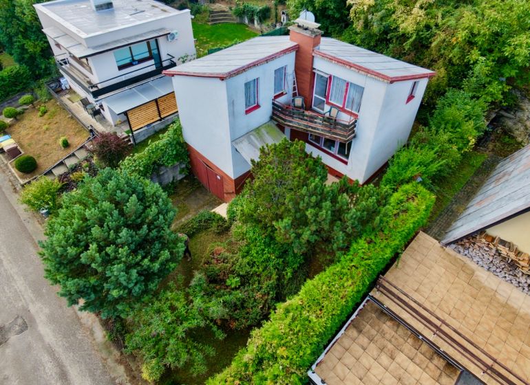 A cottage on Rekreačná Street in Vrbové surrounded by greenery and ornamental shrubs.
