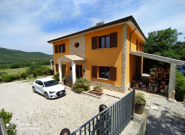 Villa on G. Puccini Street in Perugia with countryside in the background.