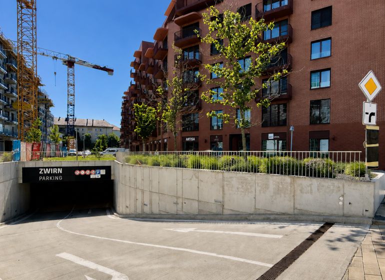 ZWIRN parking lot on Svätoplukova Street in Bratislava, surrounded by buildings and cranes.