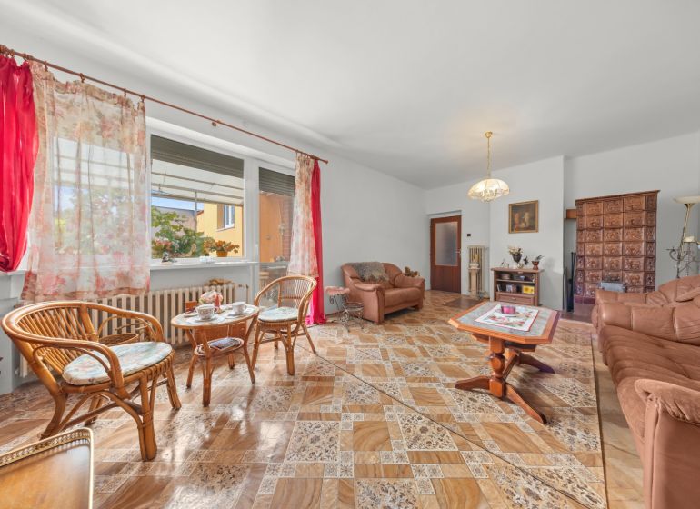 Living room in a family house with comfortable furniture and a wooden decor floor.