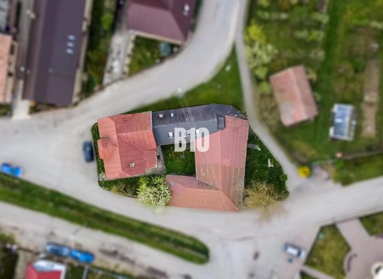 An aerial view of a family house in Púchov surrounded by roads and green areas.